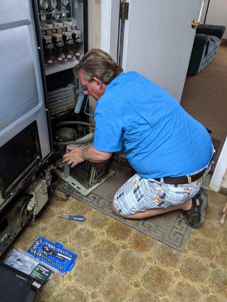 Repairman Blane Rustan working on a machine