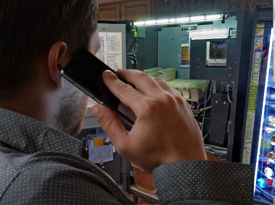 An owner discussing a vending machine problem by phone